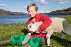 Duncan on Leckmelm Farm with a pet lamb
